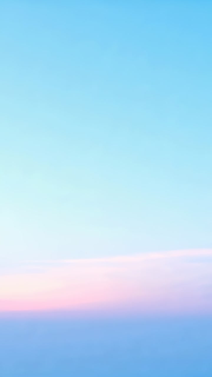Vertical video: Showing sky gradient shifting at sunrise, with low pastel cloud band near horizon