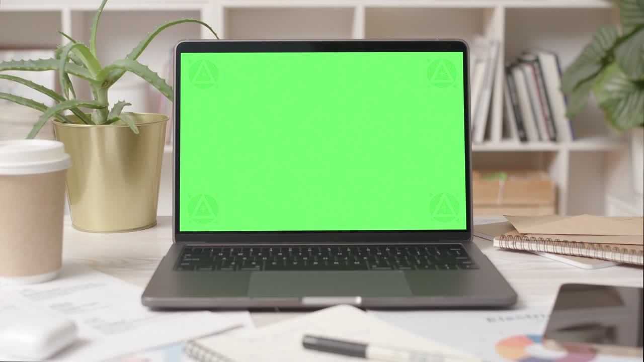 Laptop Computer with Green Screen in Cozy Office Interior