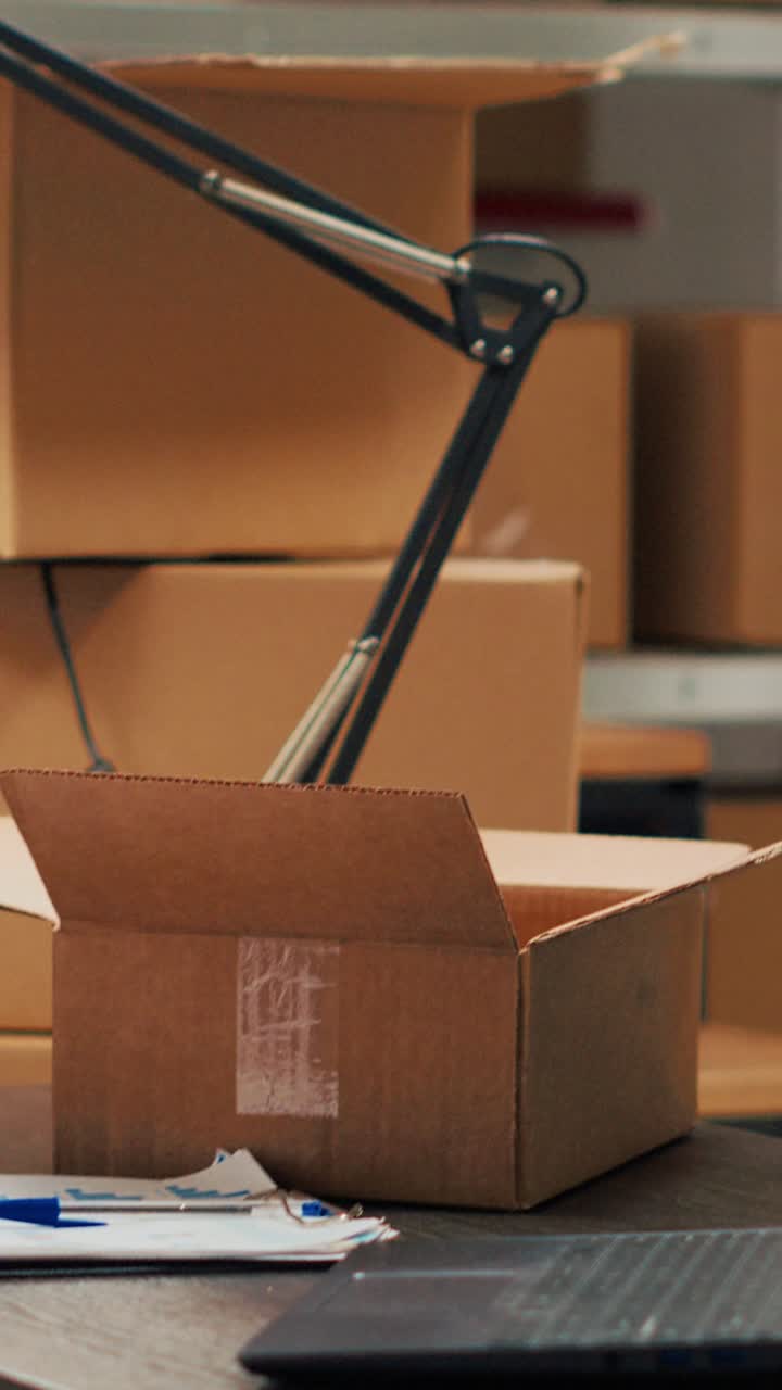 Vertical video: Warehouse filled with racks and shelves to put cardboard boxes