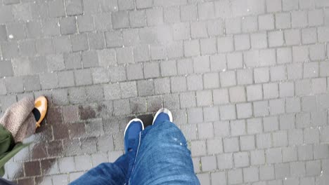 person walking on a wet city street