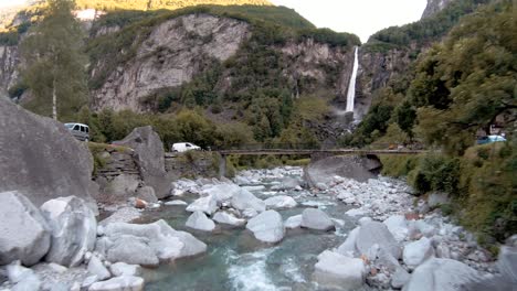 FPV-aerial-drone-shot-of-waterfall-near-town-of-Foroglio,-Ticino,-Switzerland