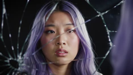 a reflective journey: exploring emotions through the broken mirror's perspective in a stunning portrait of a pensive individual with unique hair color