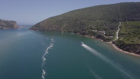 Tour-boat-full-of-passengers-motors-to-head-of-lagoon-on-scenic-cruise