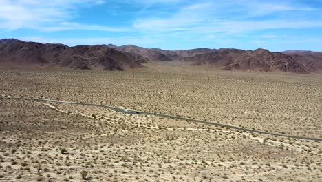 Panoramic-View-Of-Desert-With-Asphalt-Road-Through-Joshua-Tree-National-Park-In-California,-United-States