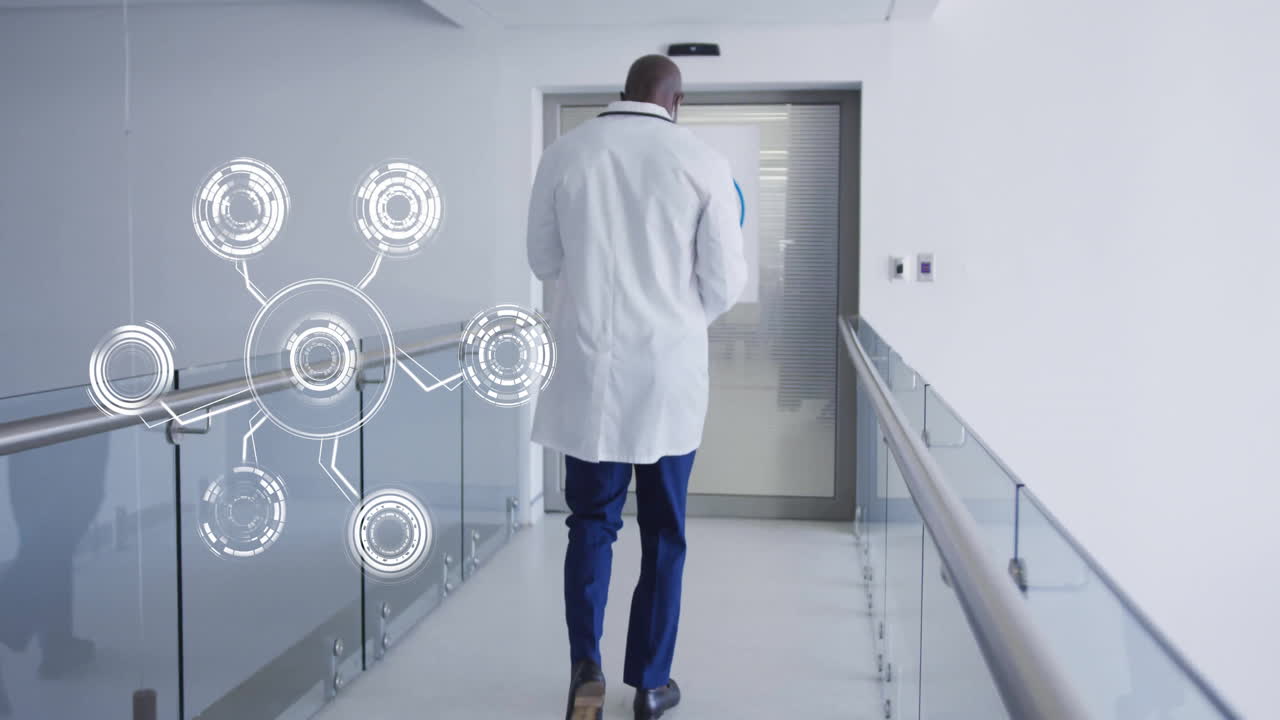 Doctor walking in hospital corridor with digital network animation overlay