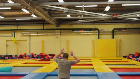 man doing a flip at trampoline park