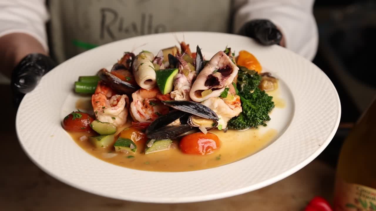Chef Presenting a Gourmet Seafood and Vegetable Dish