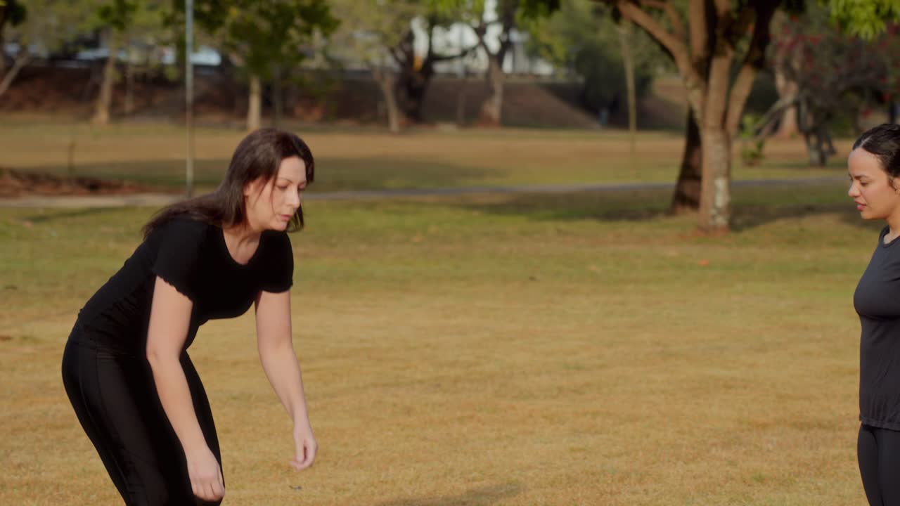 Two Women in Sportswear in a Park