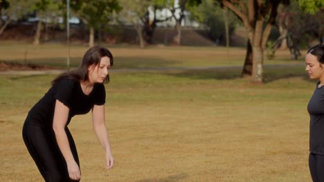 two women in sportswear in a park