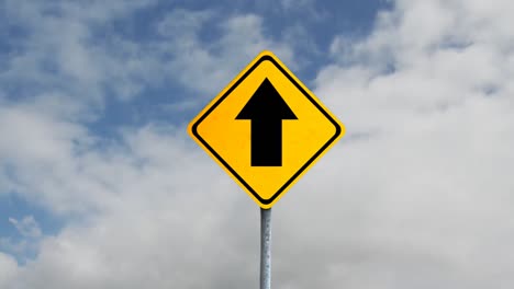 animation of  yellow road sign with the sky in the background