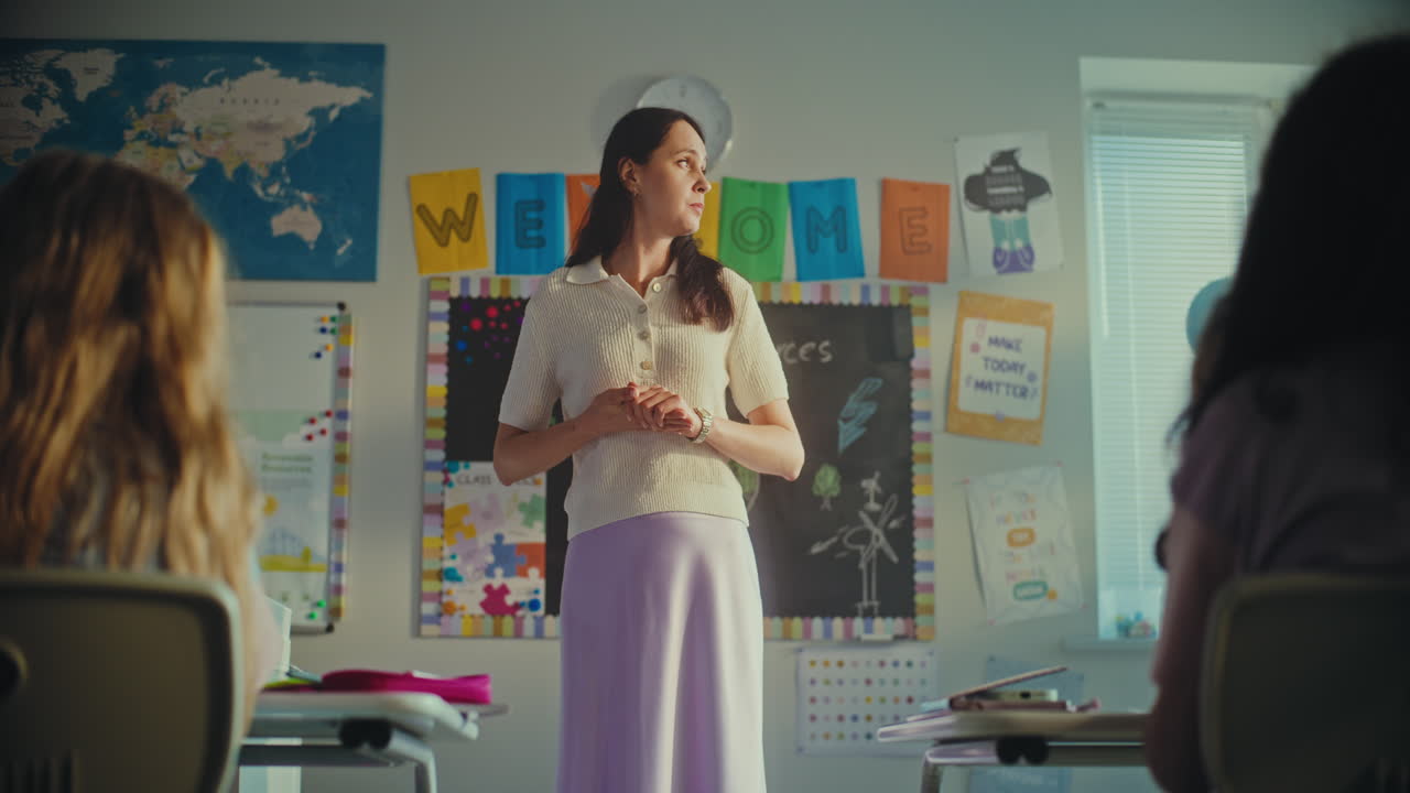 Female Teacher Greeting her Students Before Starting Math Lesson