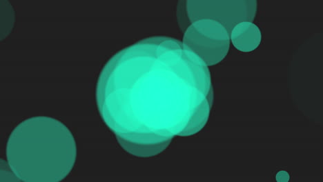 círculos verdes borrosos vibrantes sobre un fondo negro
