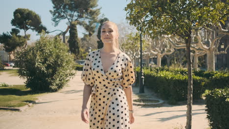 stylish young woman walking through the park.