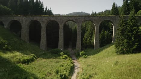 flying forward under the chmarocsky viaduct and ascending above a forest