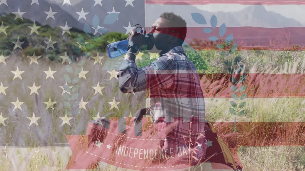 Animation of independence day text over african american man drinking water in mountains