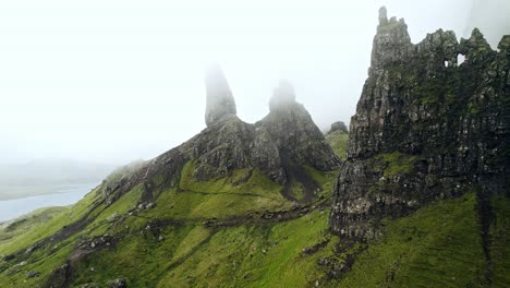 epic aerial shot circling famous old man of storr on a cold foggy day, scotland