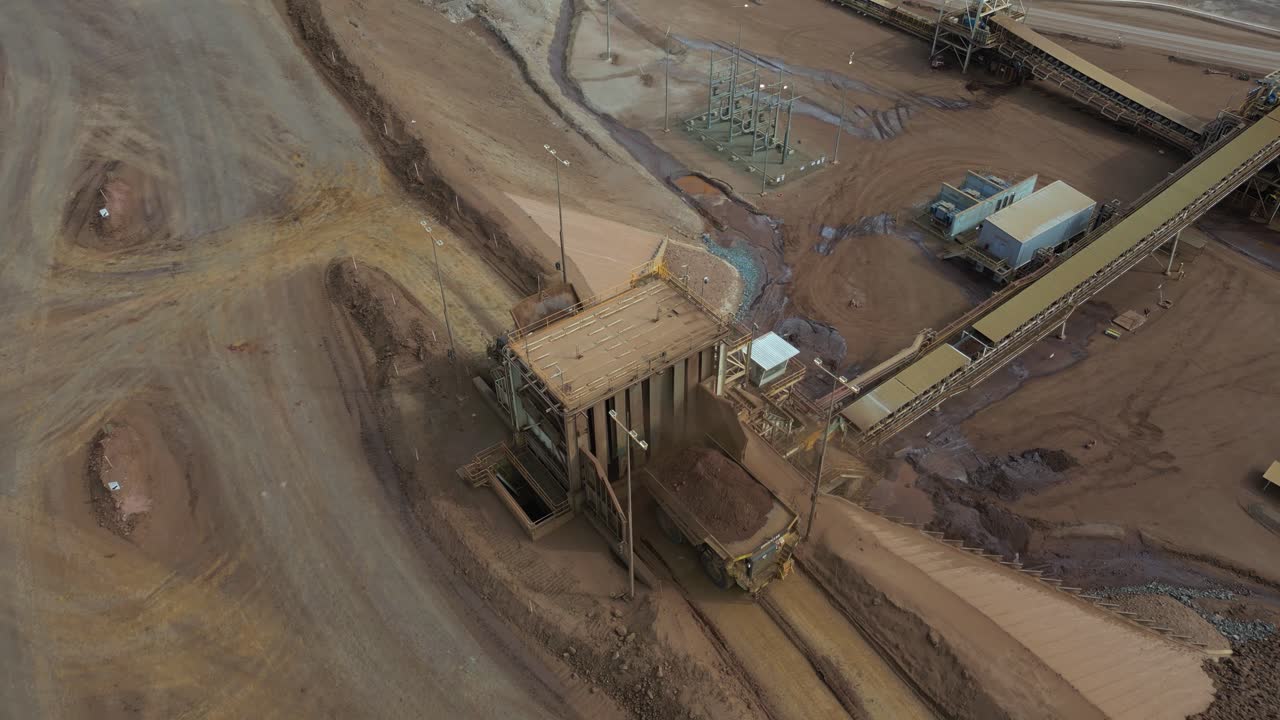 Aerial view of a nickel mine where a huge truck is unloading