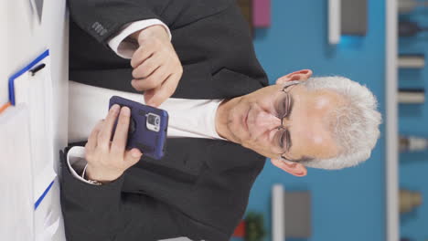 vertical video of home office worker man having problems and stress on the phone.