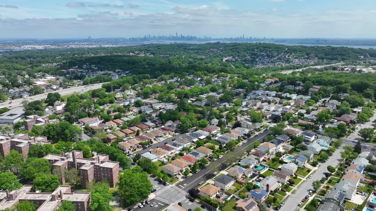 Aerial view of suburb neighborhood on Staten island with Greebelt Forest and Skyline of Manhattan in background - New York City,USA