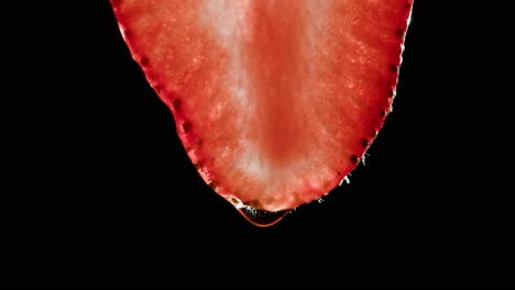 close-up of a strawberry slice with droplet