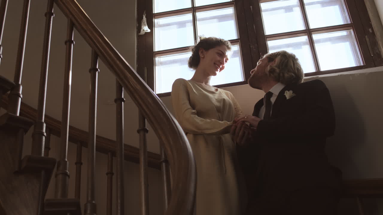 Newlyweds Standing on Staircase and Talking