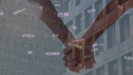 animation of changing numbers over building and diverse couple holding hands against sky