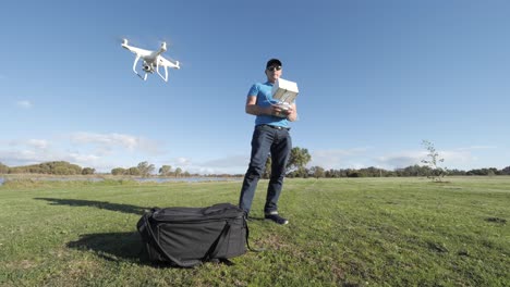 Drone-pilot-with-drone-take-off-in-foreground