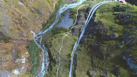 an aerial shot of a train going around the "nariz del diablo" or devil's nose in alausí, chimborazo province, ecuador