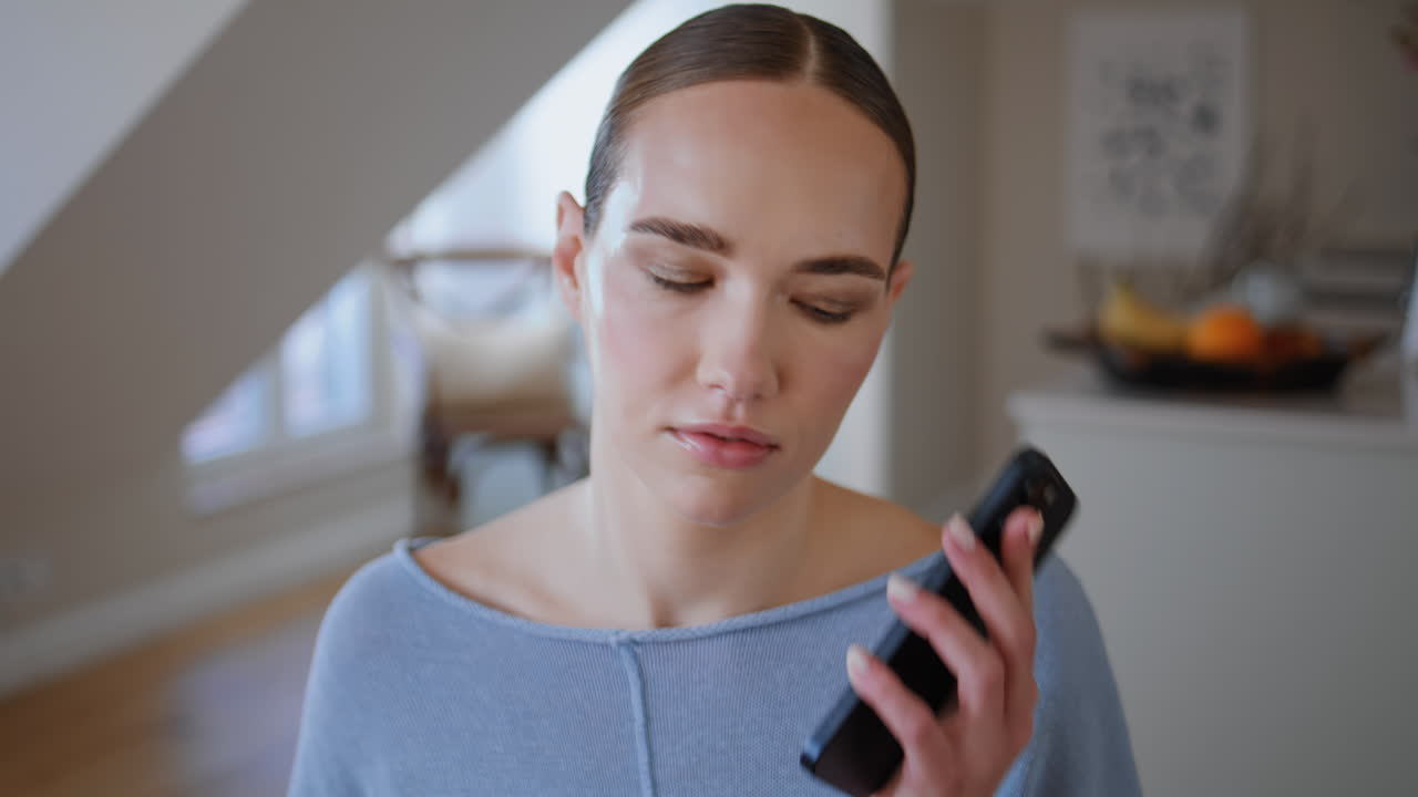 Woman chatting mobile phone in modern apartment closeup. Upset lady ending call