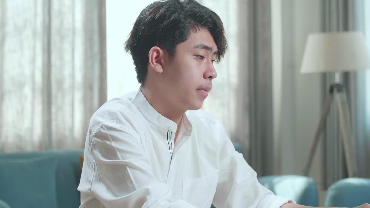 Close Up Of Asian Man Student Being Sleepy While Using Computer To Study Online At Home