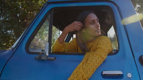 young woman on a road trip in pick-up truck