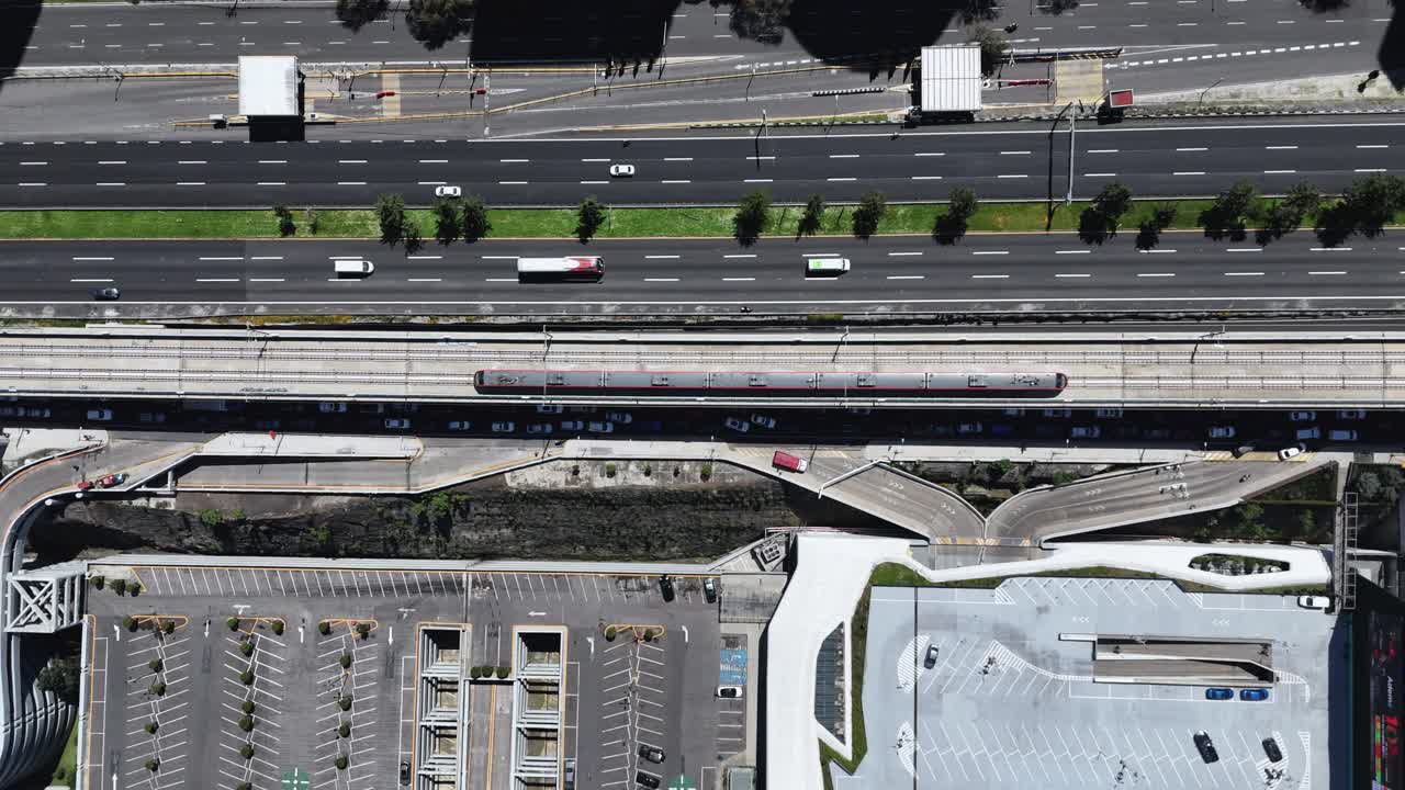 Drone footage of an intercity train crossing Santa Fe, CDMX