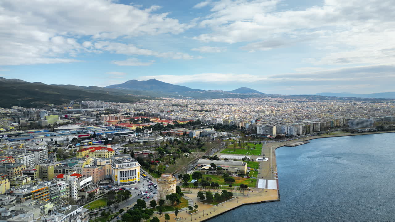 Aerial drone view of Thessaloniki coastline. Monument and museum the White Tower on the waterfront of the city. The Aegean Sea in Central Macedonia in Greece