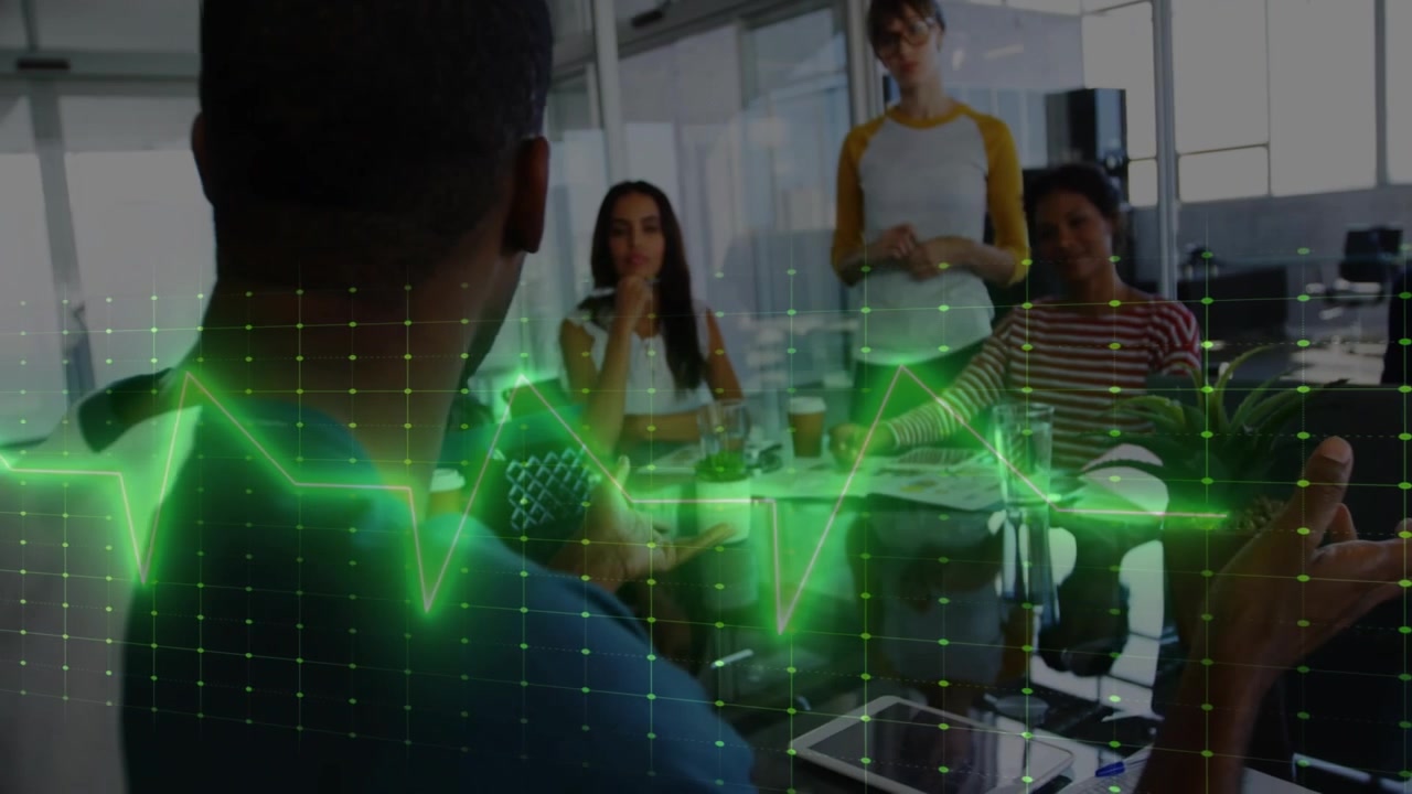 Presenter raising hands causing green waveform sweeping over glass table, guiding business meeting
