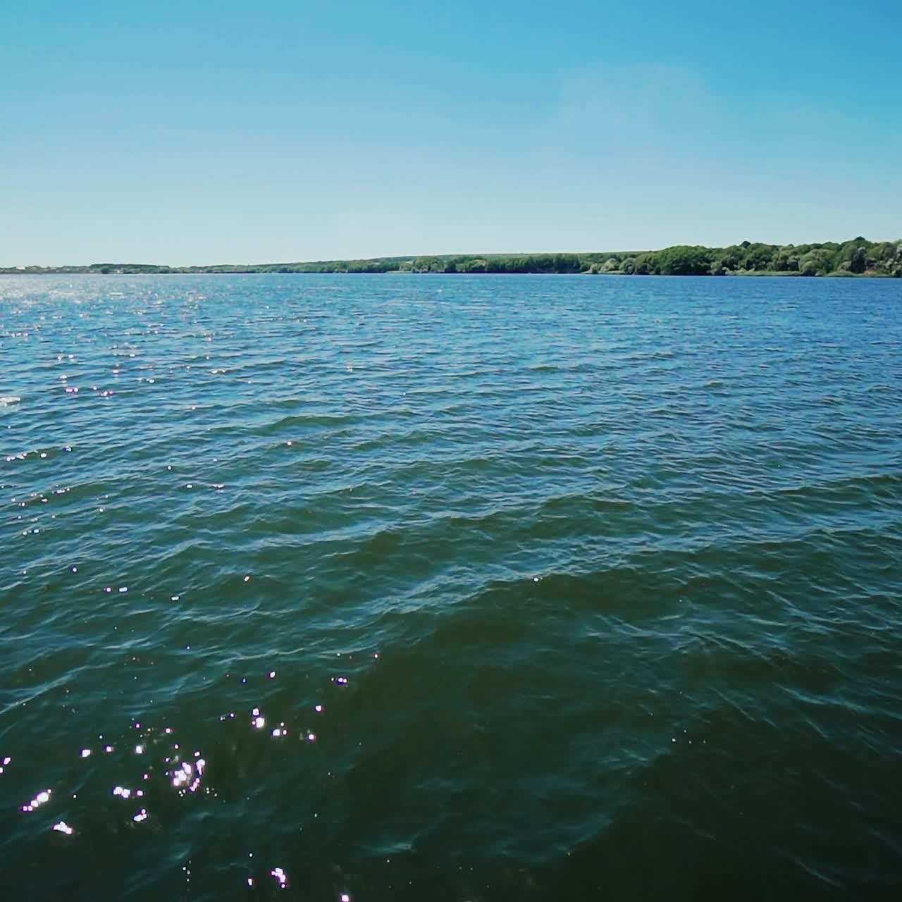 Shot of a boat bow cutting the ocean water with water splashes.