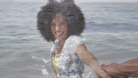 animation of happy african american couple walking at beach over sea