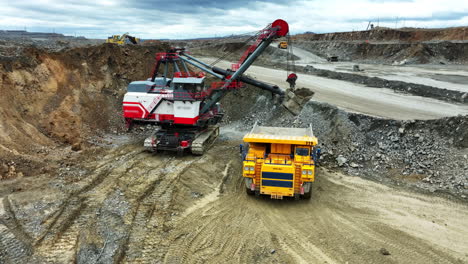 open-pit mining operation with excavator and dump truck