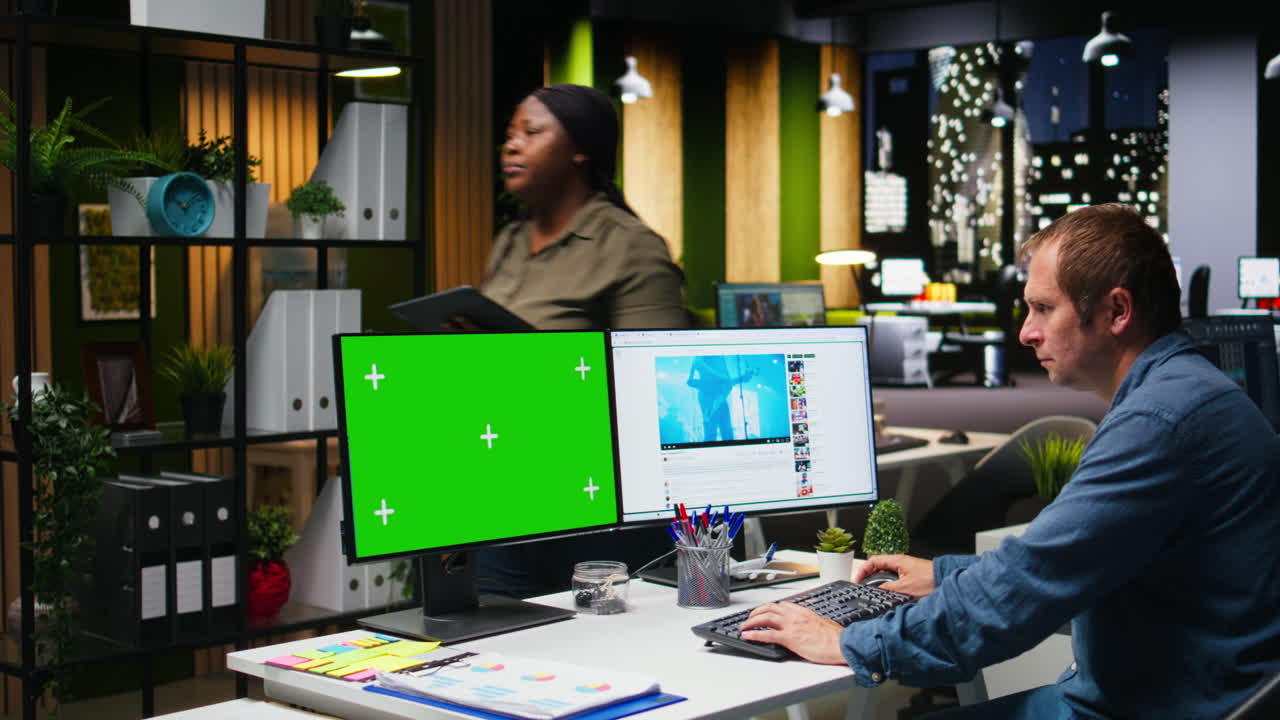 Mockup next to professional male editor checking PC reels on software in office