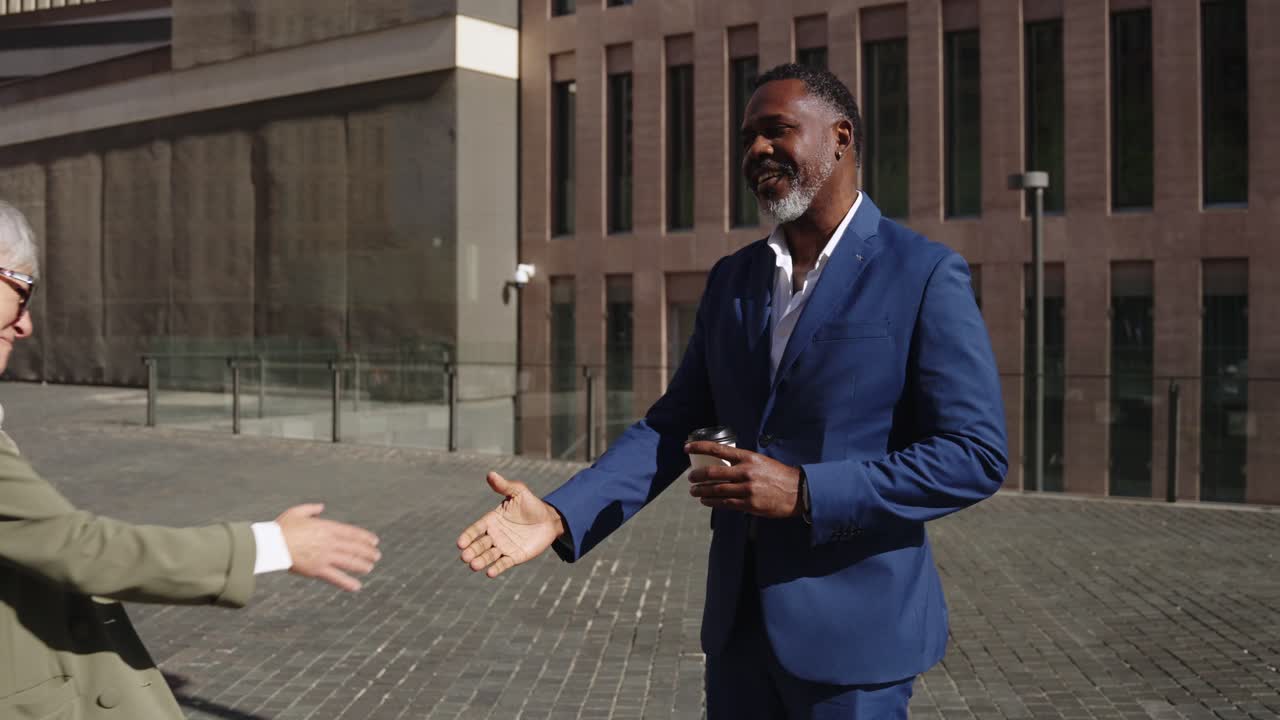 Business professionals shaking hands in an urban setting