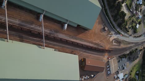 long cargo train wagons loaded with iron in esperance port area, western australia