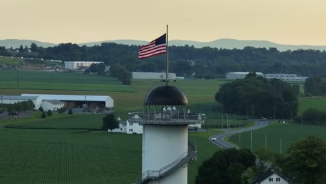 American-flag-waving-on-top-of-tower-in-rural-United-States