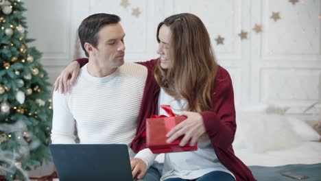 surprised man getting unexpected present in modern house. man working computer