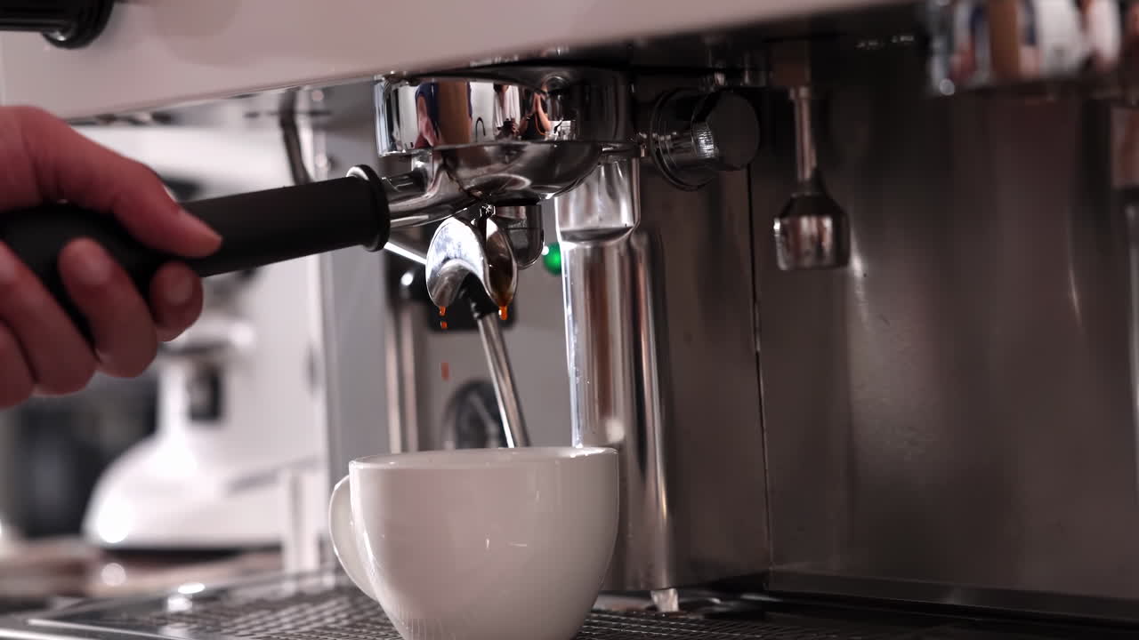 Automatic coffee machine pouring espresso into white cup during office break time, morning routine drink beverage, flowing fresh ground coffee, showcasing fresh crema and strong cafe brewing process