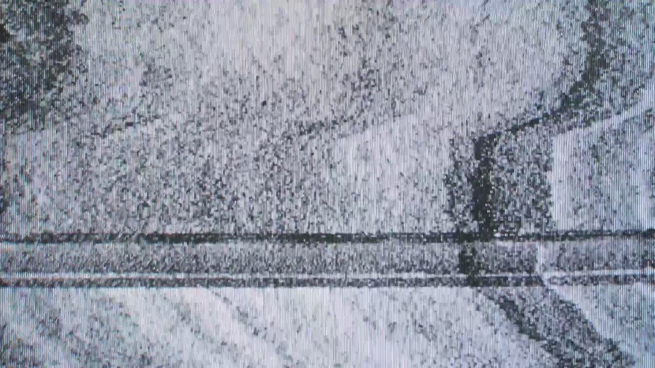 Authentic VHS tape noise with heavy static, color bleeding, and glitch effects. Seamless loop for creating a retro 80s or 90s television look. Use as an overlay or background