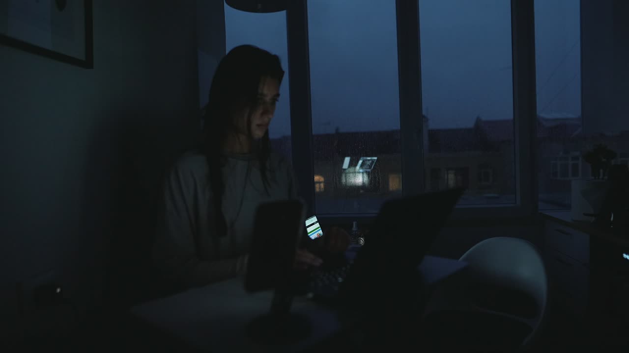Woman Working on Laptop at Night