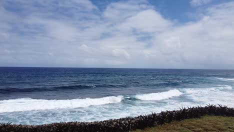 Ocean-waves-crashing-into-shoreline-drone-shot-pulling-out