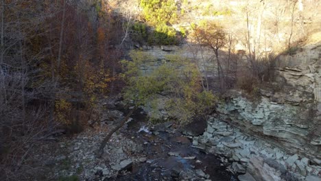 Wilderness-beautiful-landscape-aerial-dolly-in-shot-capturing-the-sediment-formation-and-spring-water-flowing-downward-at-Albion-Falls,-Hamilton,-Ontario,-Canada