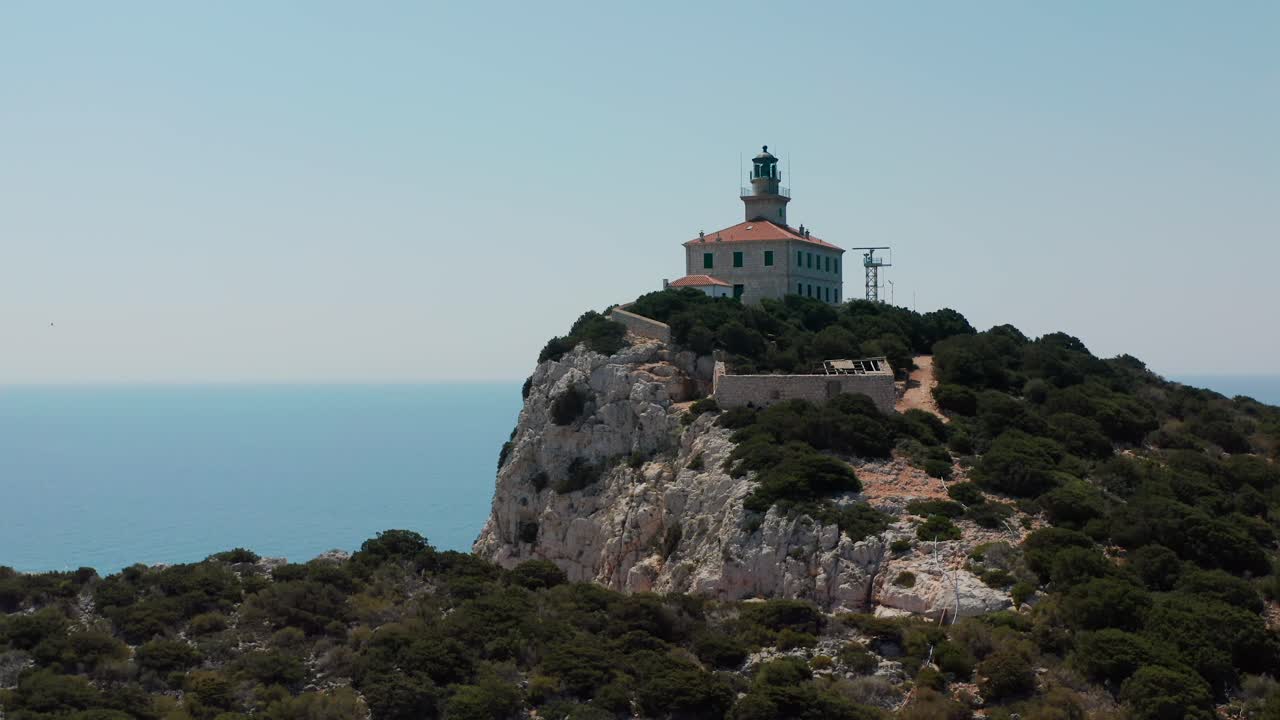 Sušac, Adriatic Sea, Croatia - A Lighthouse Perched on a Rocky, Forested Island, Overlooking the Azure Sea - Aerial Drone Shot