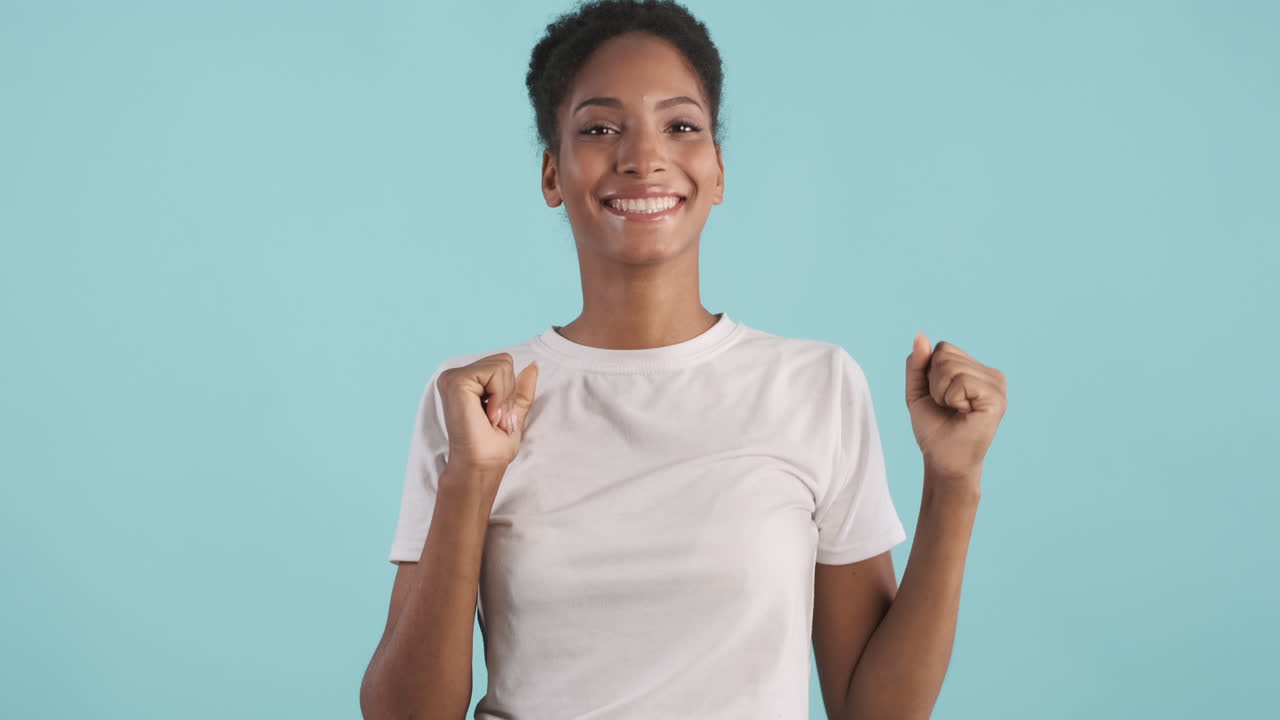 Woman in white T-shirt celebrating
