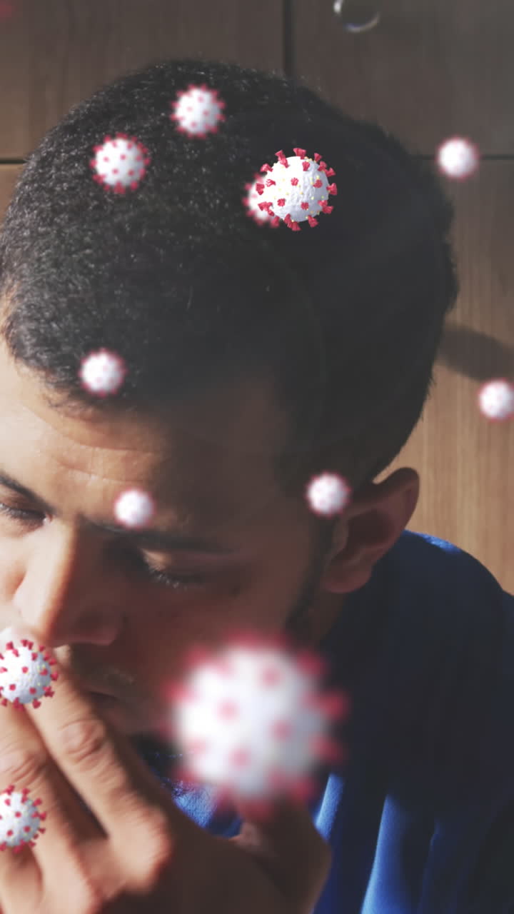 Animation of virus cells floating over biracial male football player in changing room